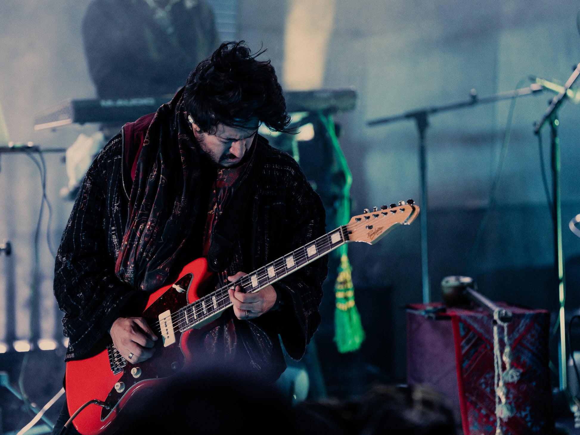 The Qaim Sherry Bomber in motion worn by Sherry Khattak, rockstar from Pakistan Coke Studio on stage at Federation Square in Naarm Melbourne, fusing performance and presence during Rising Festival.