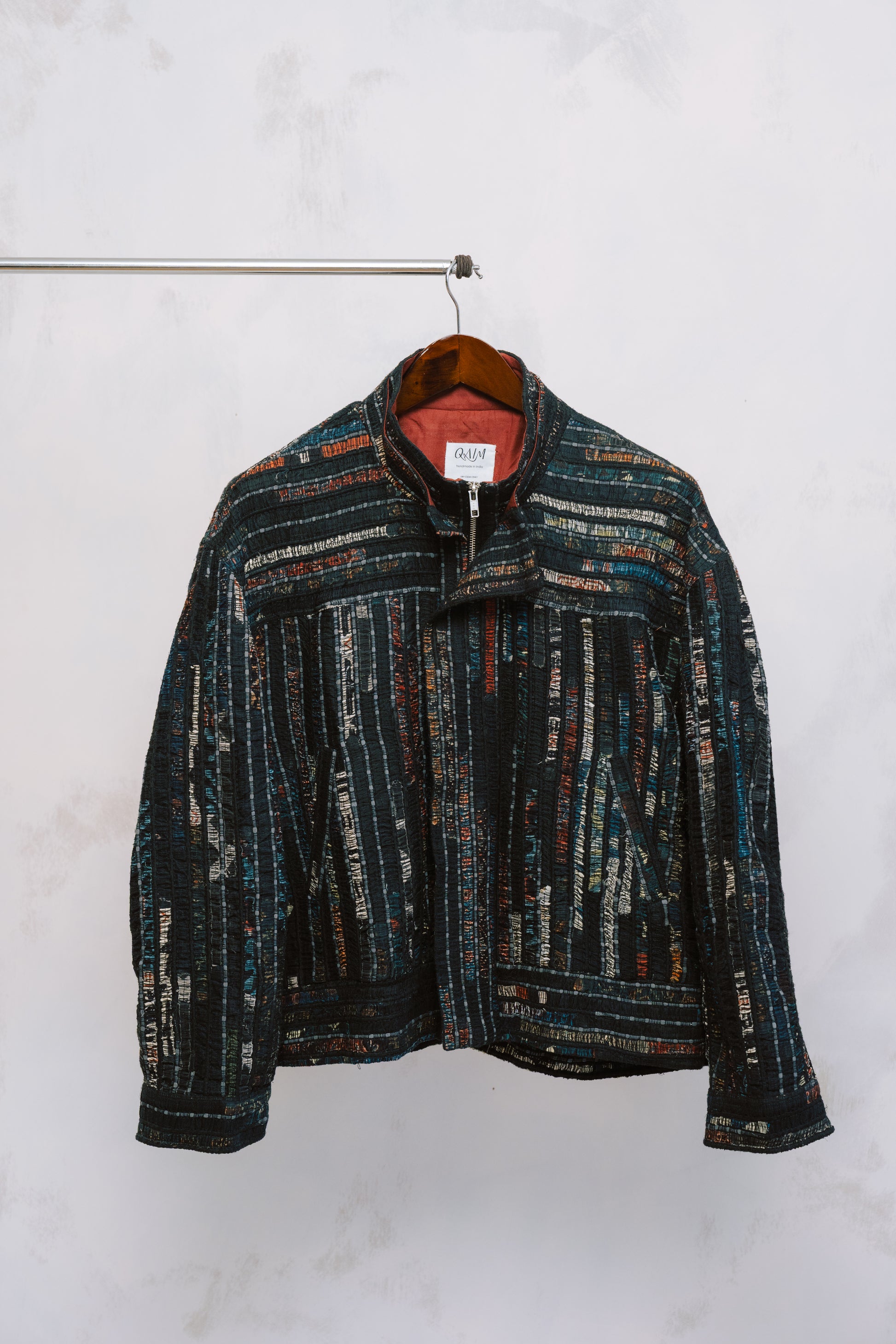 Front view of the Sherry Bomber – a structured, oversized jacket made from deep-toned upcycled fabrics, featuring a statement collar and relaxed silhouette.