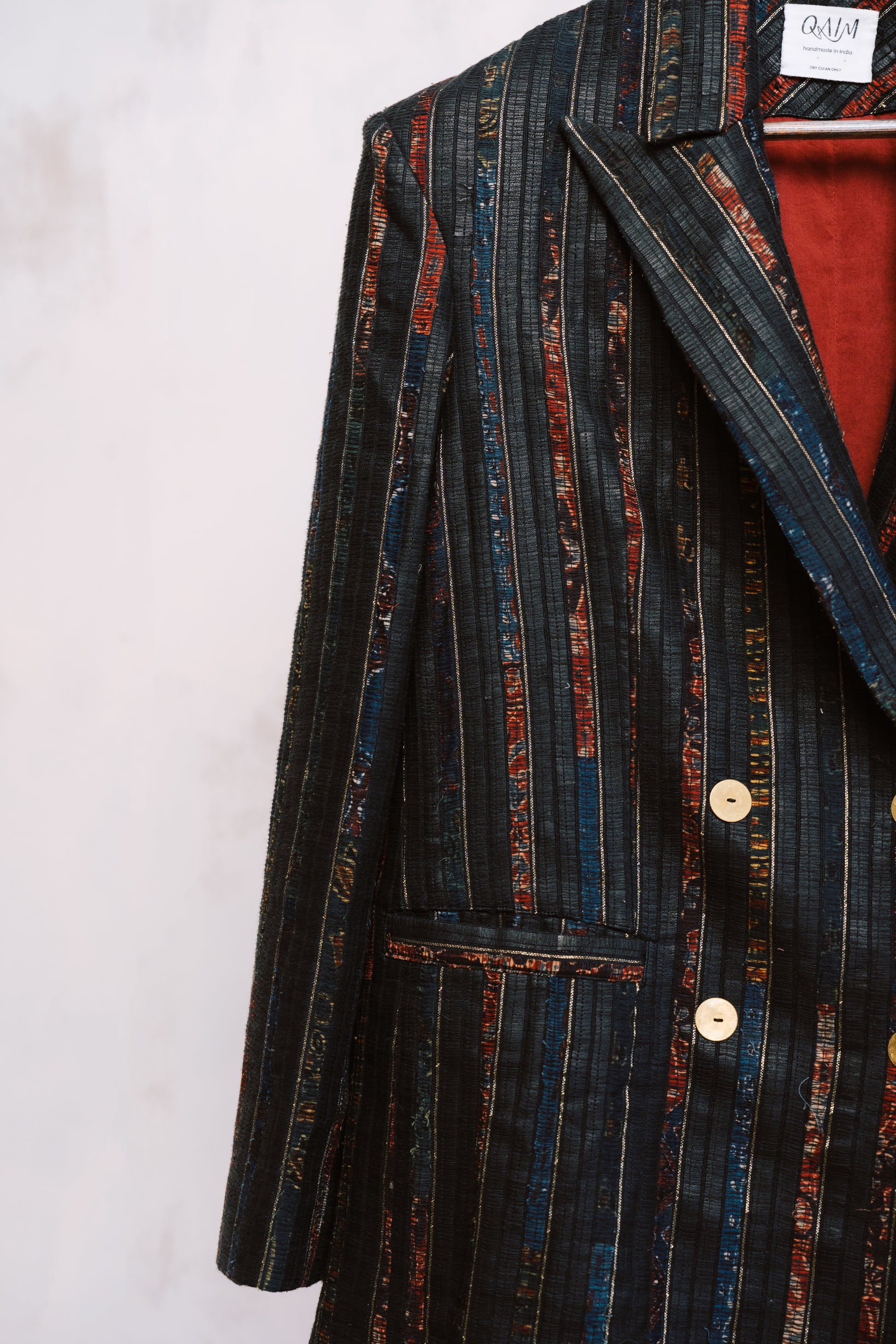 Striped blazer with a red lining on a white background