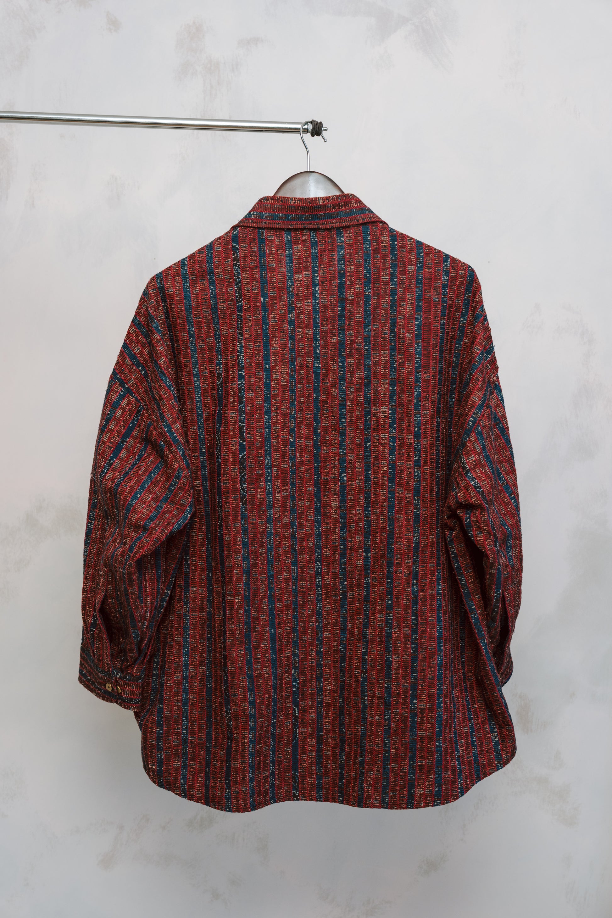 Flat lay of the Studio Red Zulfi Overshirt featuring reclaimed Ajrak textile on a neutral background.