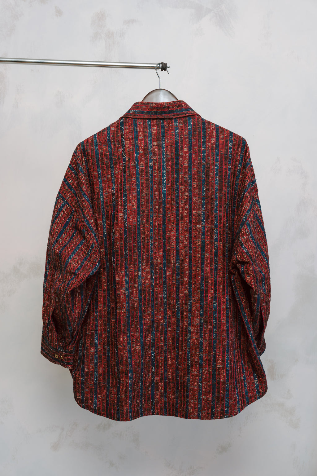 Flat lay of the Studio Red Zulfi Overshirt featuring reclaimed Ajrak textile on a neutral background.