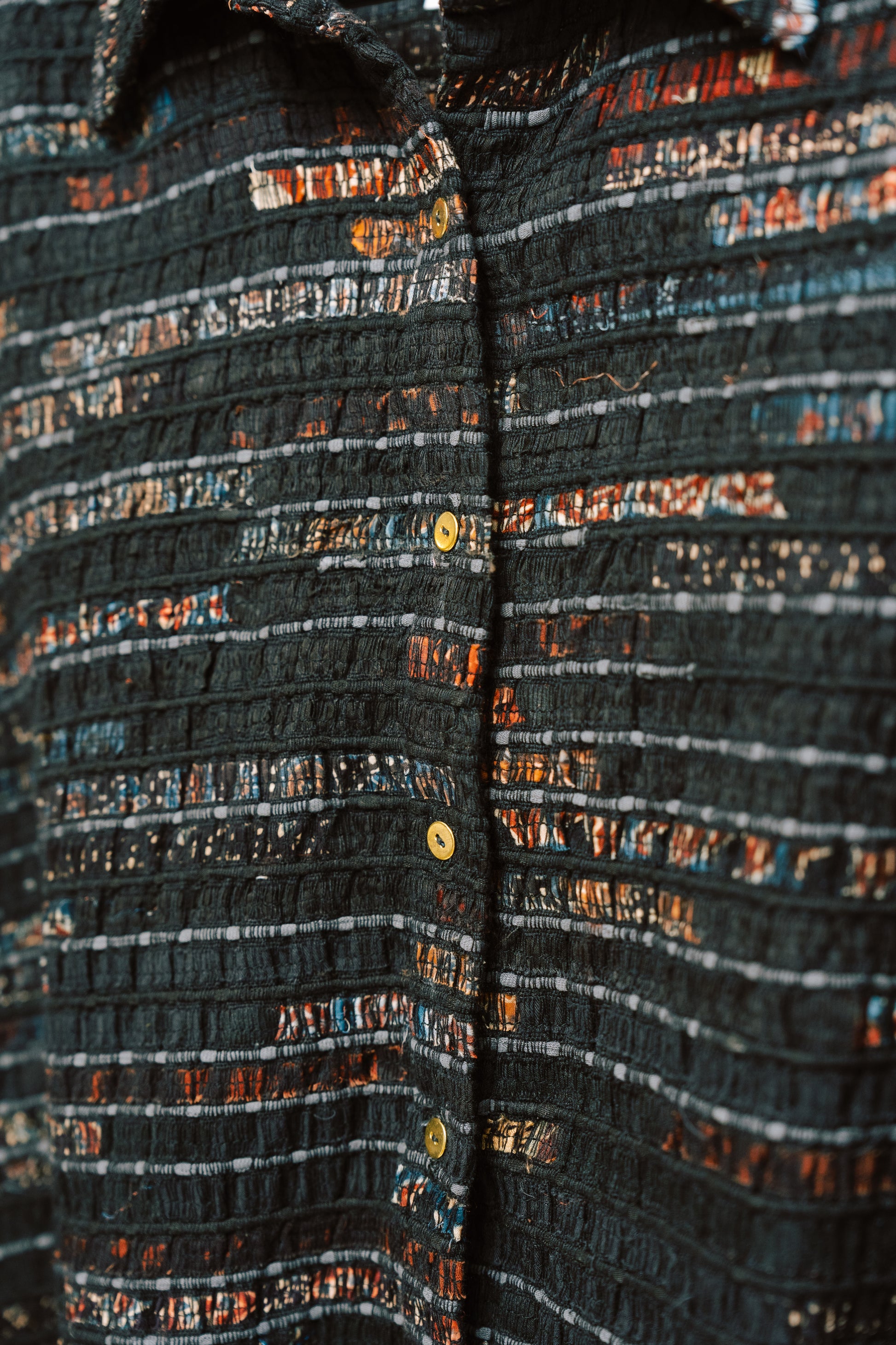 Close-up of the Elianne Overshirt’s fabric, showing the mix of textures and stitching from upcycled cotton and reclaimed panels. Visible thread work and natural variation highlight the garment’s handmade nature