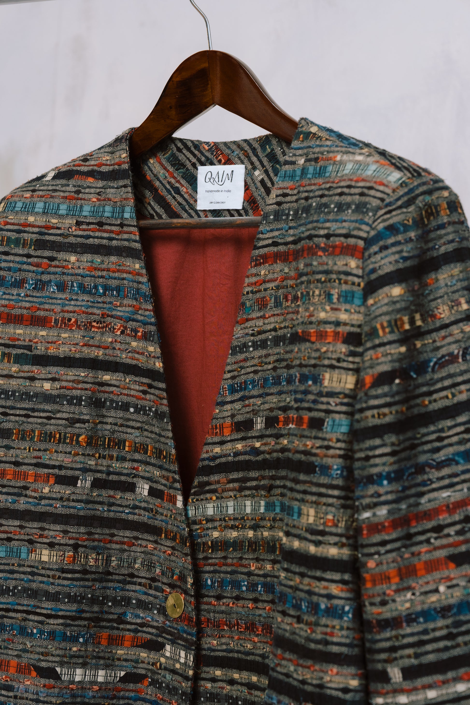 Close-up of the Ash Coat’s shoulder, showing strong tailoring and rich ajrak weave stitched into the lining.