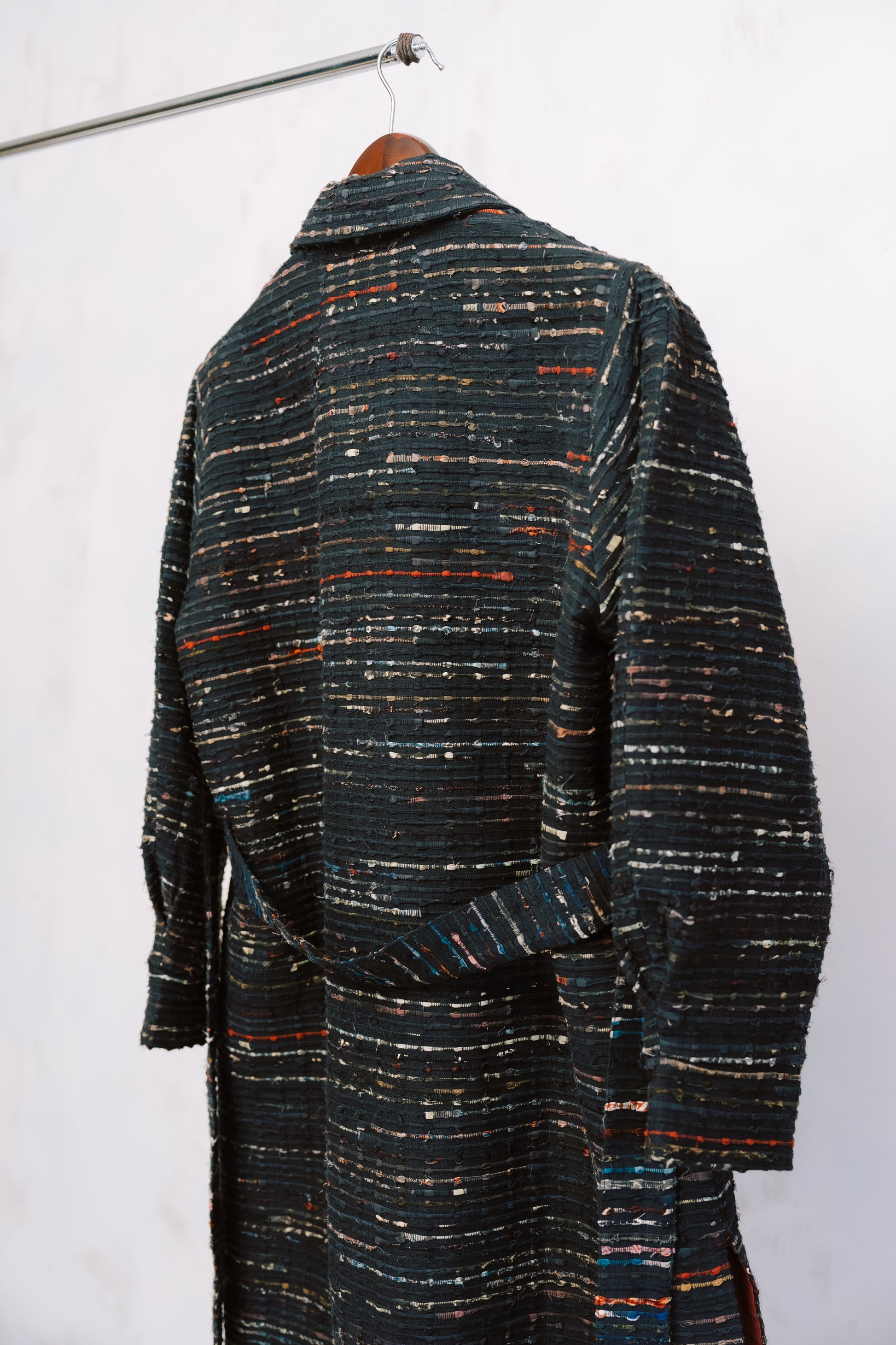 Textured coat with multicolor pattern on a white background