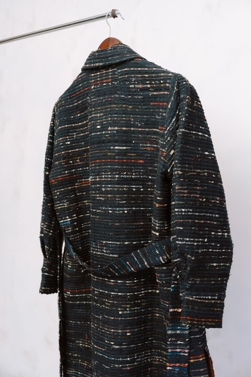 Textured coat with multicolor pattern on a white background